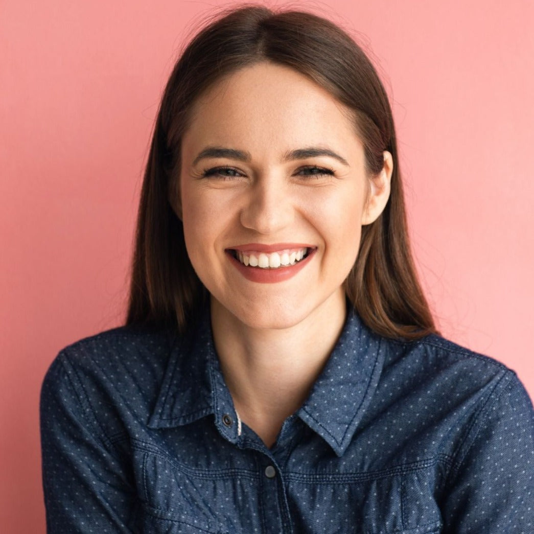 smiling brunette woman with bright pink background portrait photography chicago